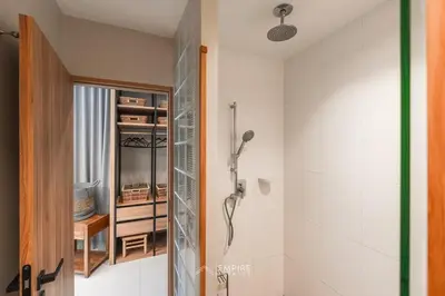 a bathroom with a shower and a glass door at Cozy Apartment with Pools Near the Beach in Kamala Beach