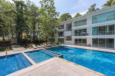 a swimming pool in front of a building at Cozy Apartment with Pools Near the Beach in Kamala Beach