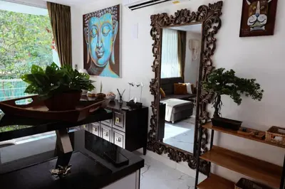 a bathroom with a large mirror and a sink at Cozy Retreat Near Beach and Pools in Kamala Beach