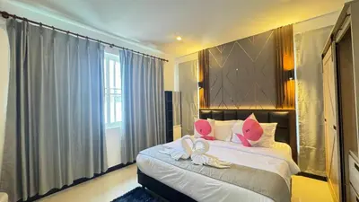 a bedroom with a bed with two swans on it at Ban Khuendee Pool Villa in Kathu