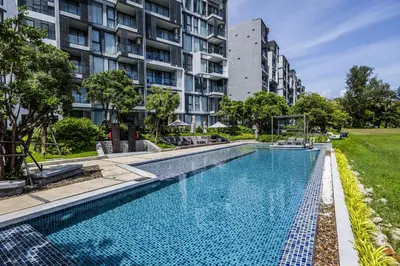 a swimming pool in front of a building at Suite Velora 3BR Pool GymCassia Laguna Phuket in Laguna Phuket