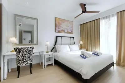 a bedroom with two beds and a desk and a mirror at Suite Velora 3BR Pool GymCassia Laguna Phuket in Laguna Phuket