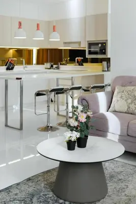 a living room with a table with flowers on it at Suite Velora 3BR Pool GymCassia Laguna Phuket in Laguna Phuket