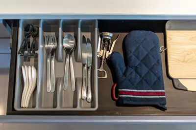 a drawer with silver utensils and a glove at Suite Ruse 1BR Rooftop Pool ViewCitygate Kamala in Kamala Beach