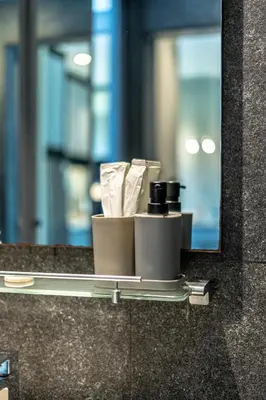 a mirror on a counter with toiletries at Suite Ruse 1BR Rooftop Pool ViewCitygate Kamala in Kamala Beach