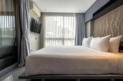 a bedroom with a large bed and a window at Luxury 1BR Resort Retreat by IBG Property P514 in Kamala Beach