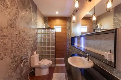 a bathroom with a sink and a toilet at Karon Bliss Sea View Villa with Private Pool in Karon Beach