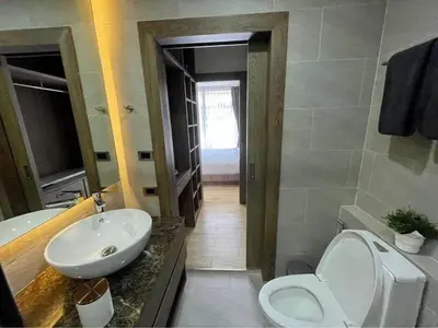 a bathroom with a white toilet and a sink at Sea Breeze 2 Bedrooms Rawai Naiharn Beach in Rawai Beach