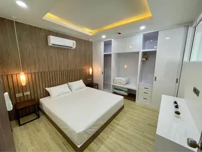 a bedroom with a large white bed and a bathroom at Sea Breeze 2 Bedrooms Rawai Naiharn Beach in Rawai Beach