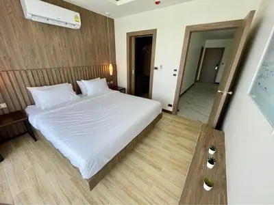 a bedroom with a large white bed and a mirror at Sea Breeze 2 Bedrooms Rawai Naiharn Beach in Rawai Beach