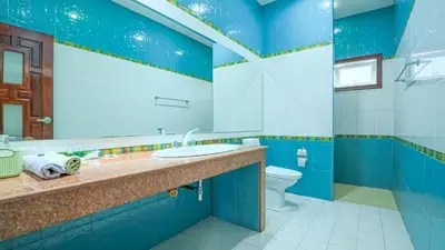 a blue bathroom with a sink and a toilet at Sundrenched Oasis 7bed pool villa heart of Phuket in Kathu