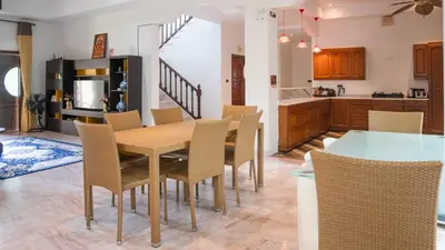 a kitchen and dining room with a table and chairs at Sundrenched Oasis 7bed pool villa heart of Phuket in Kathu