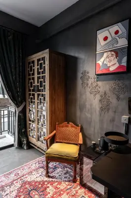 a living room with a chair and a window at Boss Level Gaming Hotel in Rawai Beach