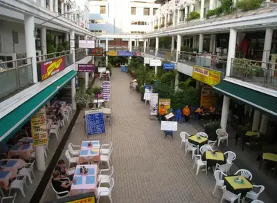 an empty street with tables and chairs in a building at Apartment with jacuzzi - Patong Tower by lofty in Patong Beach