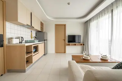 a kitchen and living room with a couch and a table at Suite Blue Horizon 2BR Sea View Fantasea Kamala in Kamala Beach