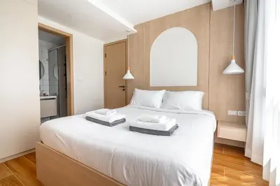 a bedroom with a large white bed with two pillows at Suite Blue Horizon 2BR Sea View Fantasea Kamala in Kamala Beach