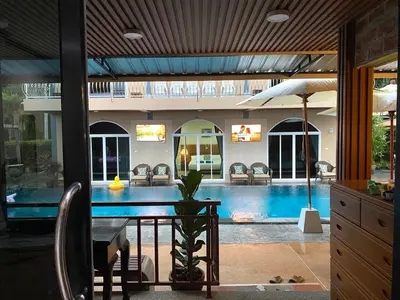 a dining room with a table and a swimming pool at Kalamung Resort and Pool villas in Ao Nang Beach