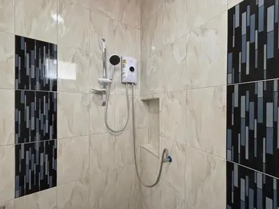 a shower in a bathroom with a shower at Kalamung Resort and Pool villas in Ao Nang Beach