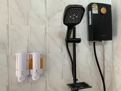 a hair dryer and a hair brush on a wall at Kalamung Resort and Pool villas in Ao Nang Beach