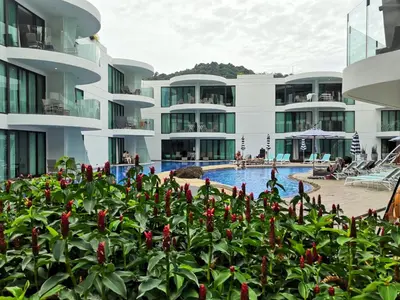 a view of a building with a swimming pool at Private apartment at Twin Sands near Merlin beach in Patong Beach
