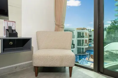 a chair in a room with a window at Private apartment at Twin Sands near Merlin beach in Patong Beach