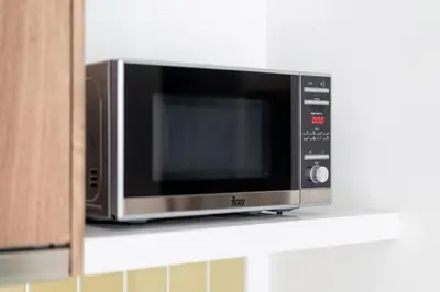 a microwave oven sitting on top of a counter at Private apartment at Twin Sands near Merlin beach in Patong Beach