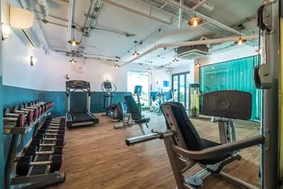a gym with cardio equipment and treadmills at Private apartment at Twin Sands near Merlin beach in Patong Beach