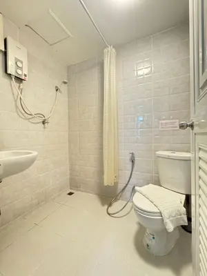 a bathroom with a toilet and a sink and a shower at La Casa Residencies in Patong Beach