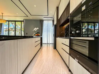 a large kitchen with black and white counter tops at The Ozone Luxury Villas Phuket in Laguna Phuket