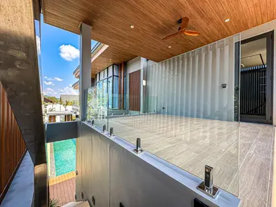 an external view of a house with a swimming pool at The Ozone Luxury Villas Phuket in Laguna Phuket