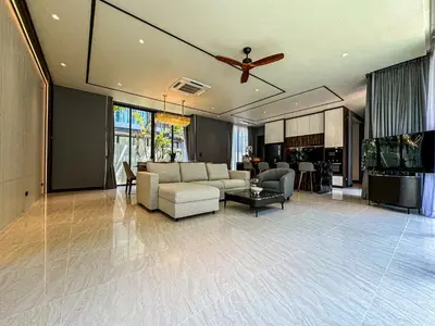 a living room with a couch and a ceiling fan at The Ozone Luxury Villas Phuket in Laguna Phuket