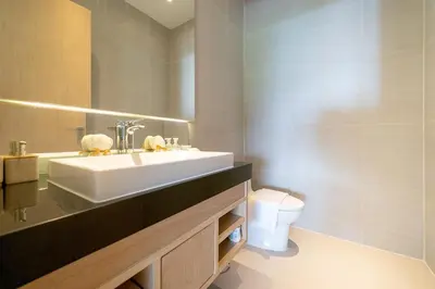 a bathroom with a sink and a toilet at The Exclusive Sky D4 \u8c6a\u534e4\u5367\u5ba4\u6d77\u666f\u522b\u5885 \u79c1\u4eba12m\u65e0\u8fb9\u6d77\u666f\u6cf3\u6c60 \u6bcf\u65e5\u6e05\u6d01 in Kamala Beach