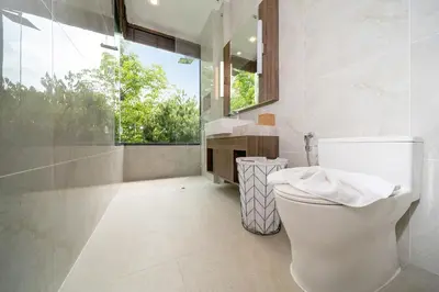 a bathroom with a white toilet and a window at The Exclusive Sky D2 \u8c6a\u534e4\u5367\u5ba4\u6d77\u666f\u522b\u5885 \u79c1\u4eba12m\u65e0\u8fb9\u6d77\u666f\u6cf3\u6c60 \u6bcf\u65e5\u6e05\u6d01 in Kamala Beach