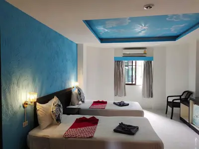 two beds in a room with a blue ceiling at Chilli House Residence in Patong Beach