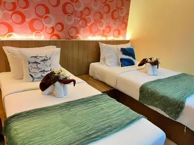 a hotel room with two beds with stuffed animals on them at Chilli House Residence in Patong Beach