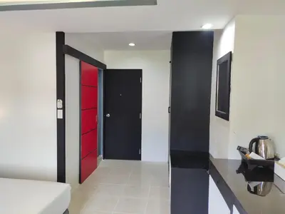 a hallway with red and black doors in a room at Chilli House Residence in Patong Beach