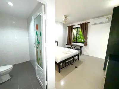 a bathroom with a bed and a toilet in a room at Patong Easy Life 1 in Patong Beach