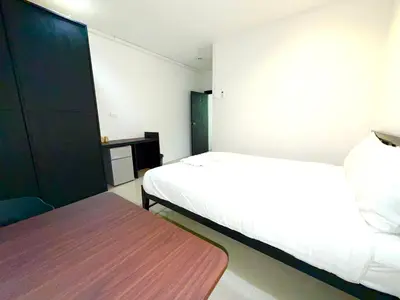 a small bedroom with a bed and a table at Patong Easy Life 1 in Patong Beach
