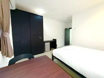 a bedroom with a bed and a table and a cabinet at Patong Easy Life 1 in Patong Beach