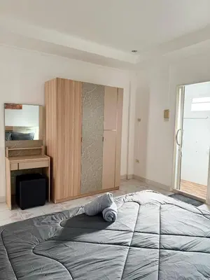 a bedroom with a large bed with a towel on it at Villa Seaview Patong in Patong Beach