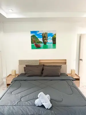 a bedroom with a bed with a towel on it at Villa Seaview Patong in Patong Beach