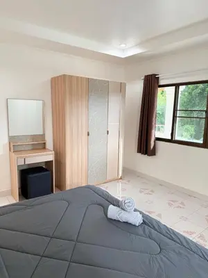 a bedroom with a large bed and a fireplace at Villa Seaview Patong in Patong Beach
