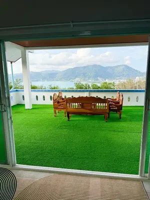 a view from the window of a room with green grass at Villa Seaview Patong in Patong Beach