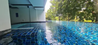 a swimming pool with blue tiles in a building at Modern studio in Boat Avenue close to the beach in Bang Tao Beach