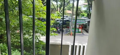 a view of a street through a window with trees at Modern studio in Boat Avenue close to the beach in Bang Tao Beach
