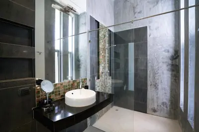 a bathroom with a sink and a mirror at Sirirat Sea-view Villa in Patong Beach