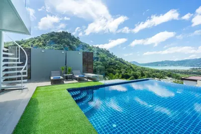a swimming pool on the roof of a house at Sirirat Sea-view Villa in Patong Beach