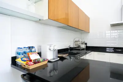 a kitchen with a sink and a counter with food at Sirirat Sea-view Villa in Patong Beach