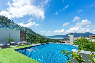 a swimming pool on the roof of a house with a view at Sirirat Sea-view Villa in Patong Beach