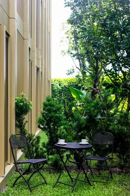 two chairs and a table in a courtyard at Private garden Laguna beachside 150 m Bangtao in Bang Tao Beach